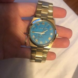 Gold Michael Kors watch with blue marble face